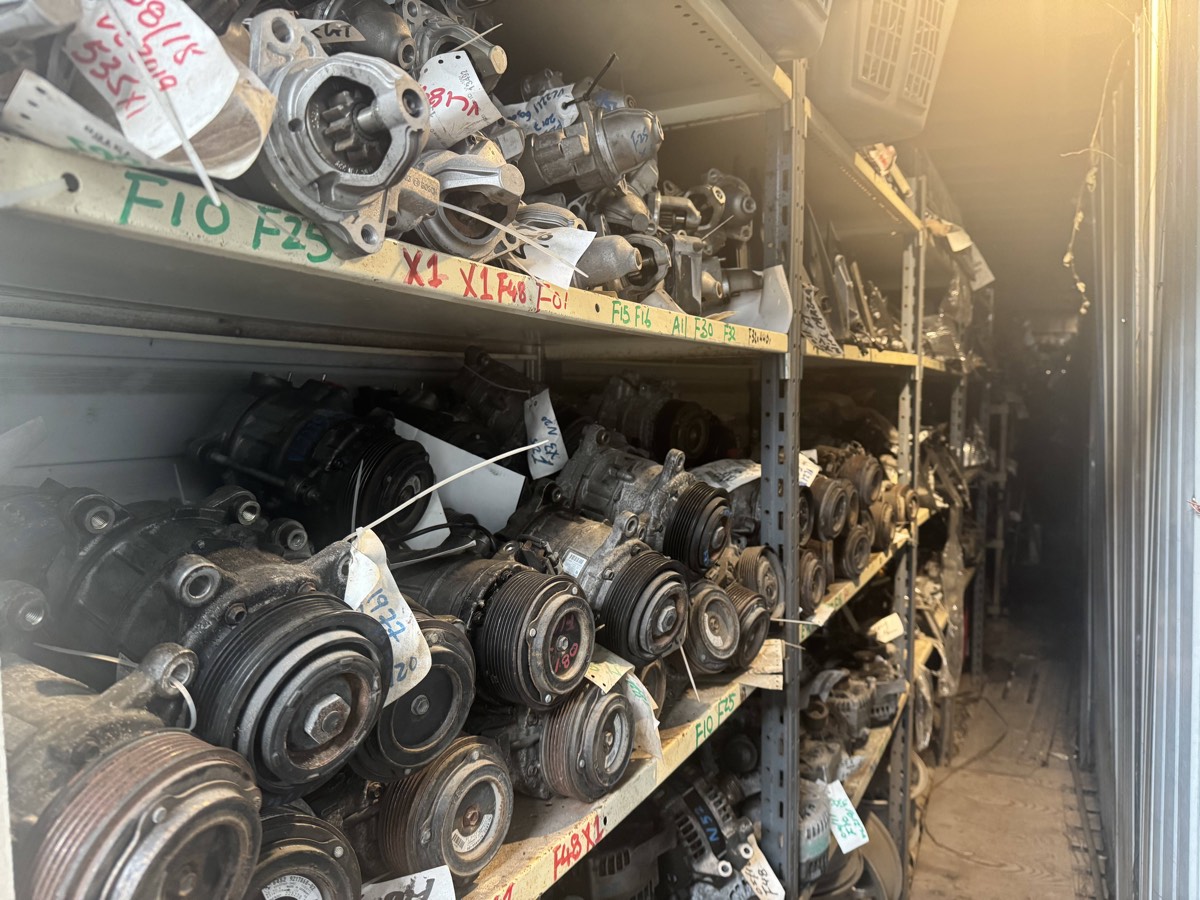 Shelves of used BMW alternators, starters and air-conditioning compressors.