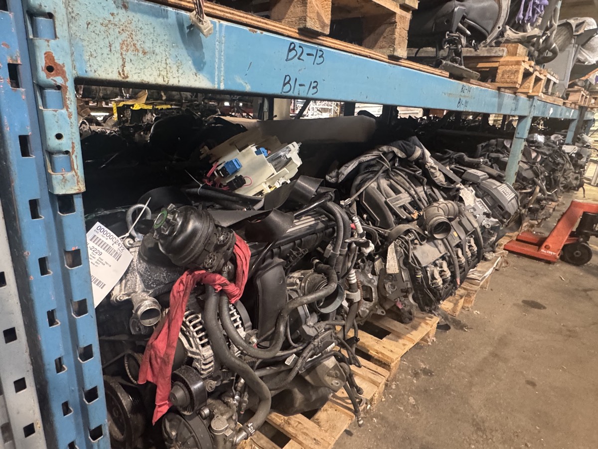Used BMW engines stored on racking in the warehouse.