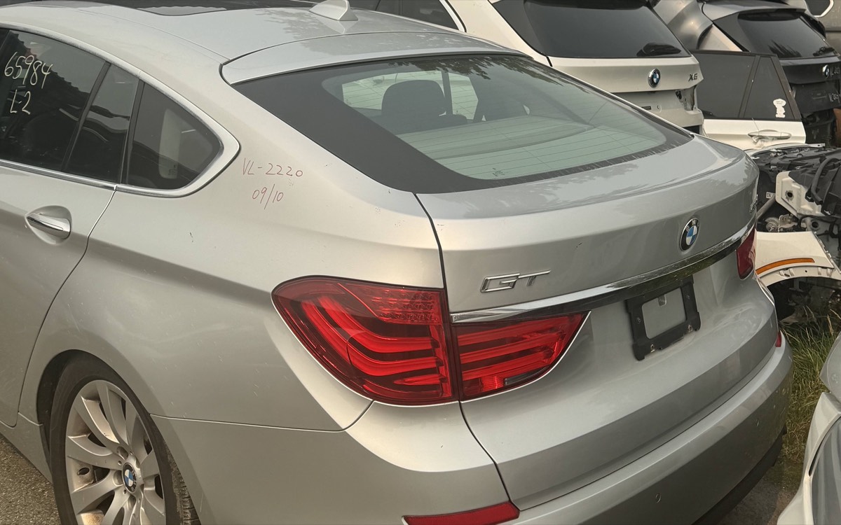 A silver BMW 5 Series GT in the yard alongside other BMW vehicles.